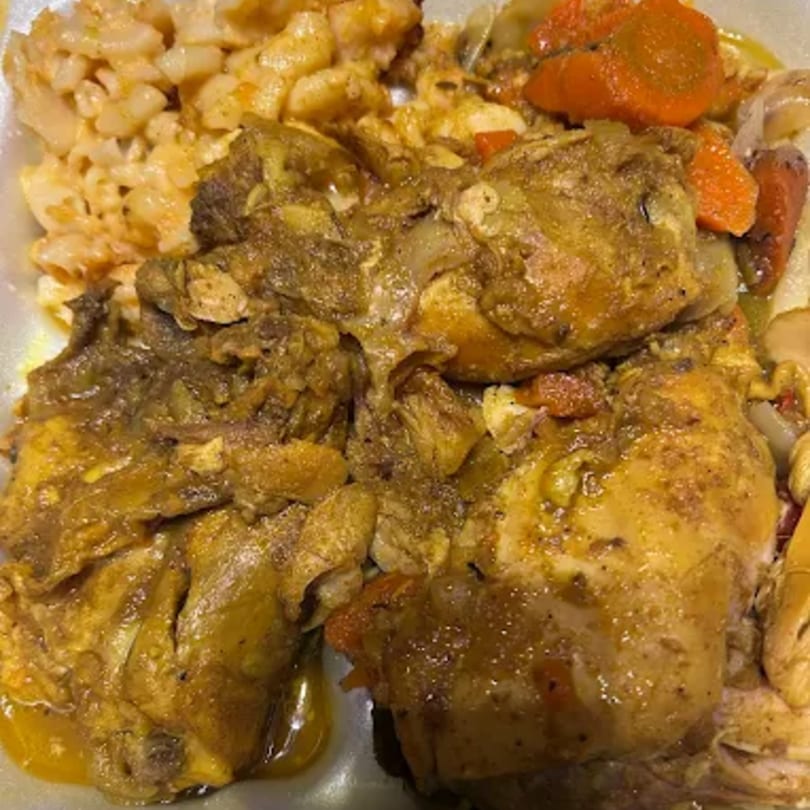 Curried chicken with carrots, onions, and a side of macaroni and cheese from The Original Jamaican Spice.